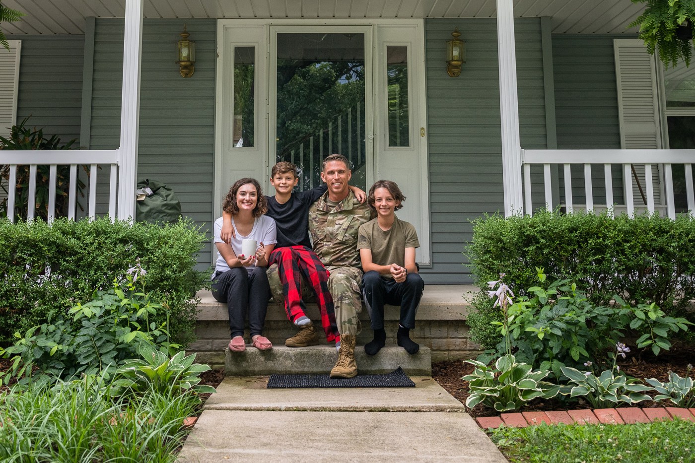 Air Force service member poses with family for group photo.